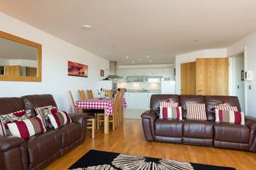 The kitchen is fitted along the back wall of this open plan space. The utility-room is through the first door on the right.