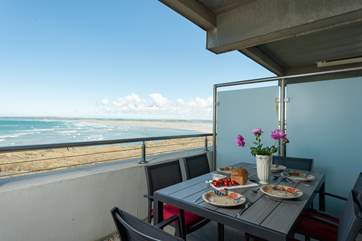 A private balcony with panoramic sea views runs the full width of the apartment with access from the living-room and the main bedroom.