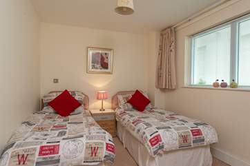 The twin bedroom is to the right as you come into the apartment. The window faces internally but has privacy blinds as well as curtains.