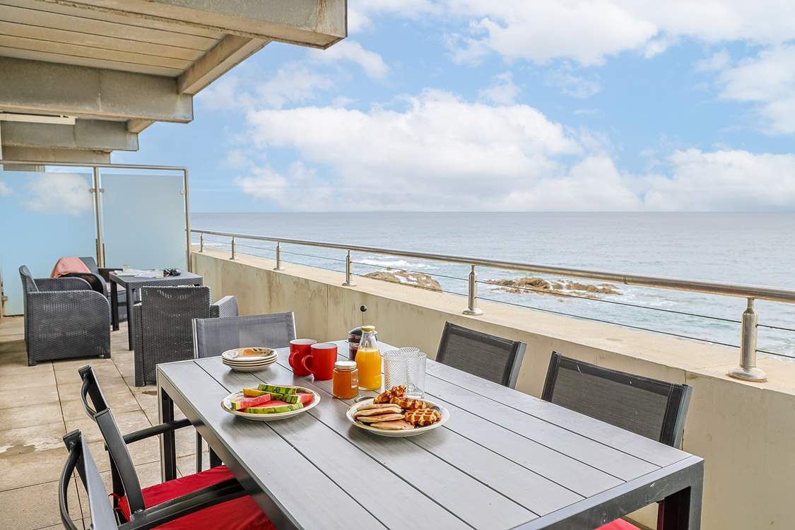 A private balcony with panoramic sea views runs the full width of the apartment with access from the living-room and the main bedroom.