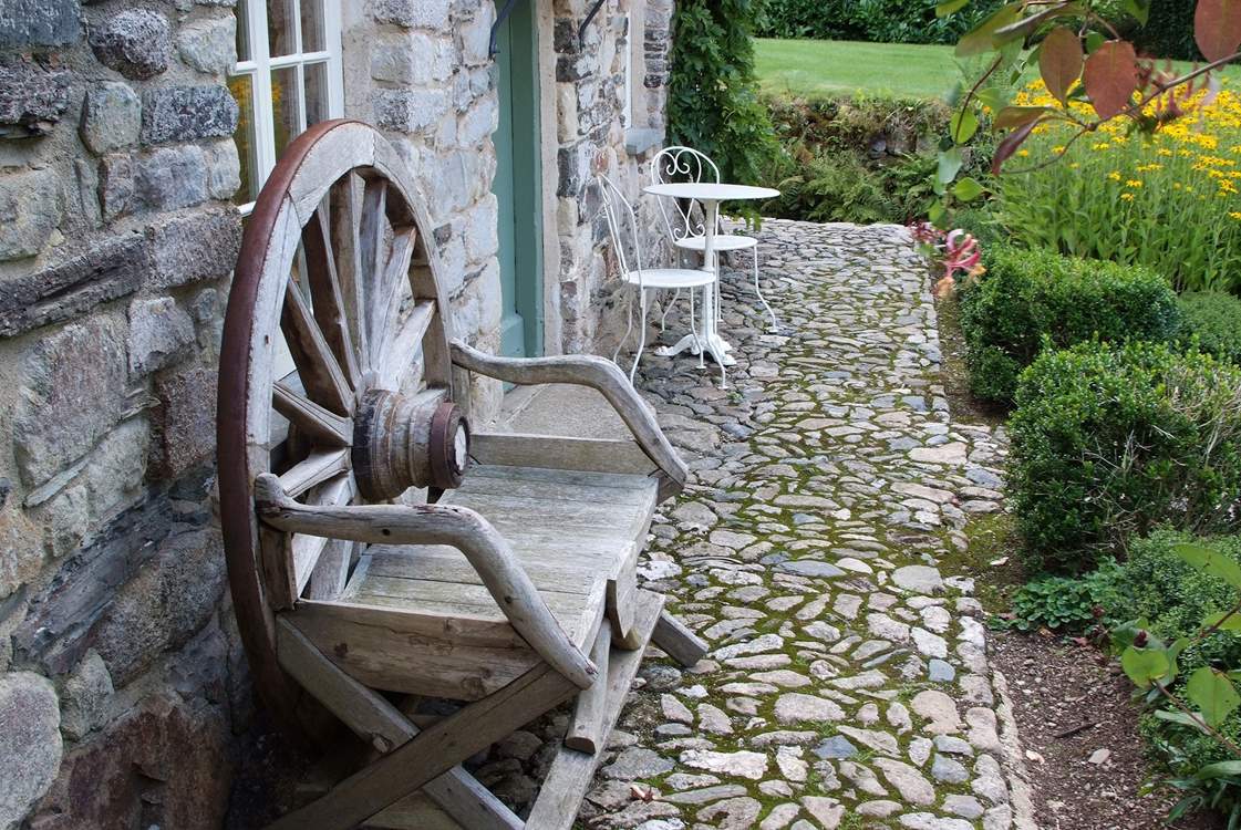 There are cobbled pathways and garden seats dotted around.