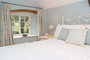 The double bedroom (Bedroom 1) in the cottage is beautifully styled.