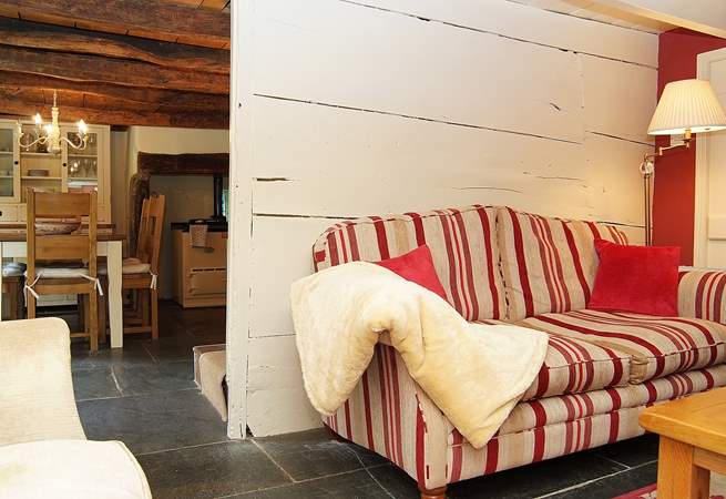 The sitting-room in the cottage side of the mill is a cosy little room with an open fire.