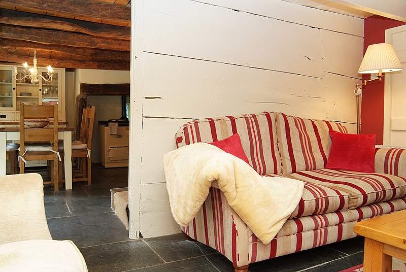 The sitting-room in the cottage side of the mill is a cosy little room with an open fire.