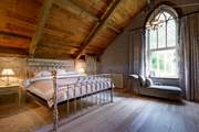 The stunning master bedroom (Bedroom 5) on the top floor of the mill.

