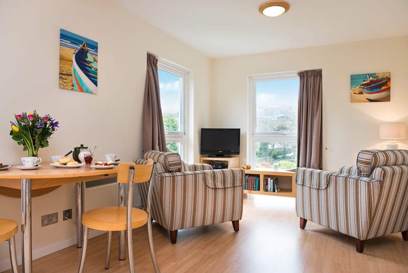 The open plan living-room has two lovely large windows, allowing the light to flood in and for you to admire the view.