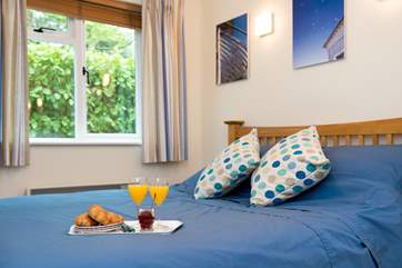 The bedroom is light and airy. Access on one side of the bed is limited.