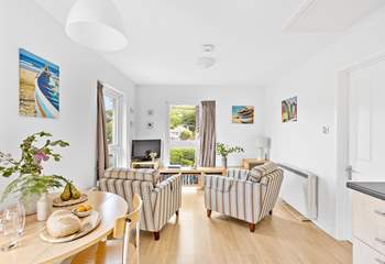 The open plan living-room has two lovely large windows, allowing the light to flood in and for you to admire the view.