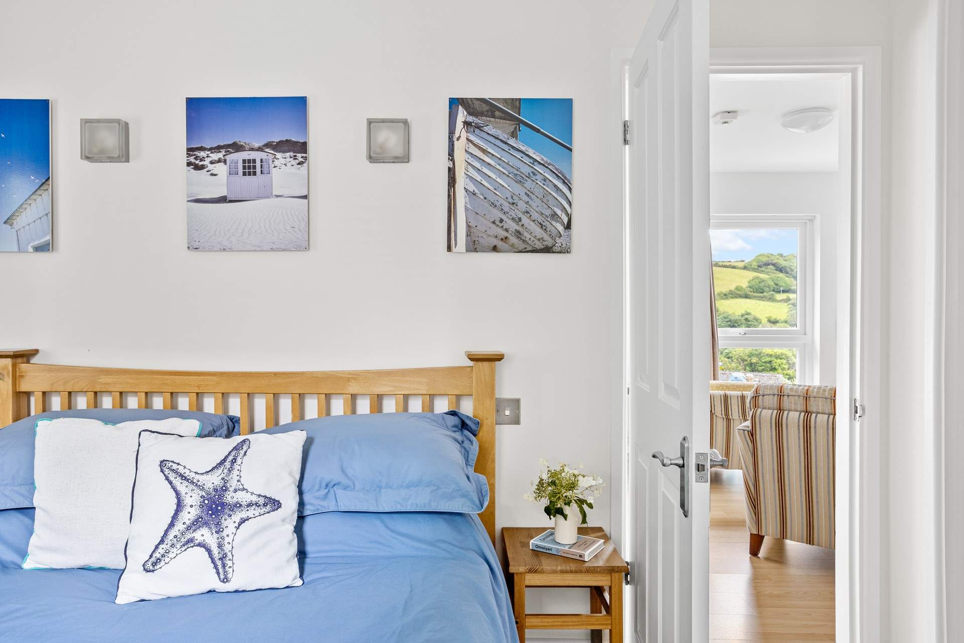 The bedroom is light and airy. Access on one side of the bed is limited.