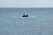 A fishing boat steaming along past Slapton Sands.