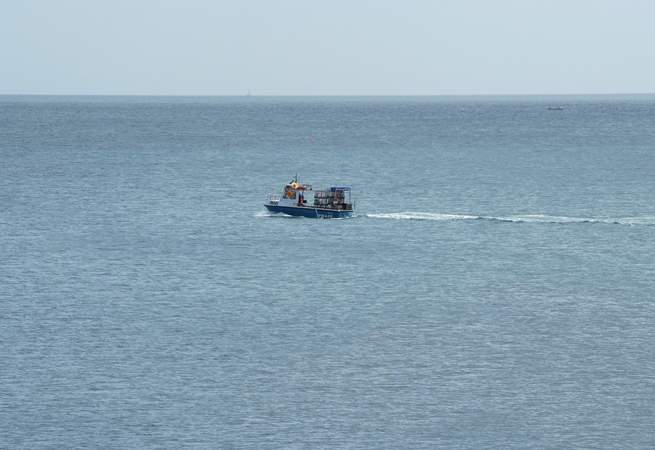 A fishing boat steaming along past Slapton Sands.