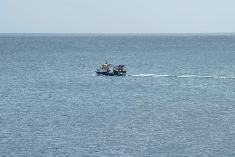 A fishing boat steaming along past Slapton Sands.
