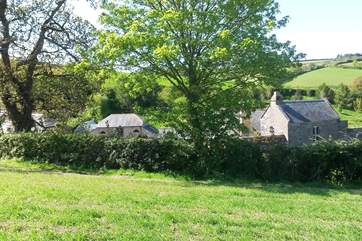 The peaceful valley at Leigh Barton with the gardener's cottage to the left, below that is Leigh Barn and Leigh Barton is across to the right.