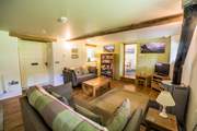 What an inviting living-room with a toasty wood-burner.
