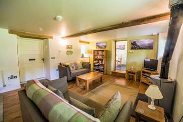 What an inviting living-room with a toasty wood-burner.
