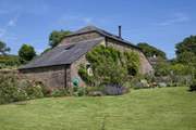 Behind Leigh Barn lies the most lovingly maintained gardens and lawn.