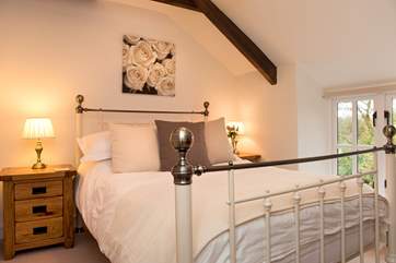 The double bedroom on the first floor has a beautiful bedstead.