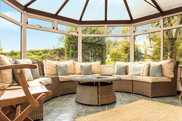 The large circular conservatory is ideal to sit in and enjoy the garden.