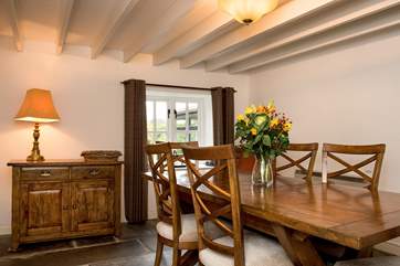 The dining-room retains the original features with its beamed ceiling and slate floor.