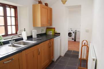 The kitchen leads through to the utility-room and bathroom.