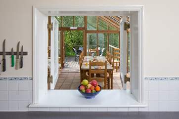 No need to feel isolated in the kitchen, a serving hatch links to the dining-room.