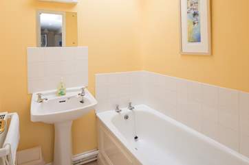The separate family bathroom is light and cheery, perfect for a soak at the end of the day.
