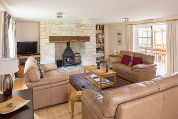 The spacious sitting-room has a cosy wood-burner and plenty of room for all the family.