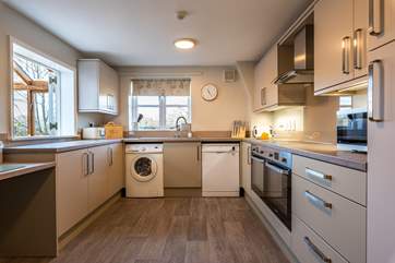A modern kitchen creates a lovely space to prepare holiday meals. There is also an area of lowered worktop making the room accessible for wheelchair users.