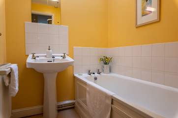 The separate family bathroom is light and cheery, perfect for a soak at the end of the day.