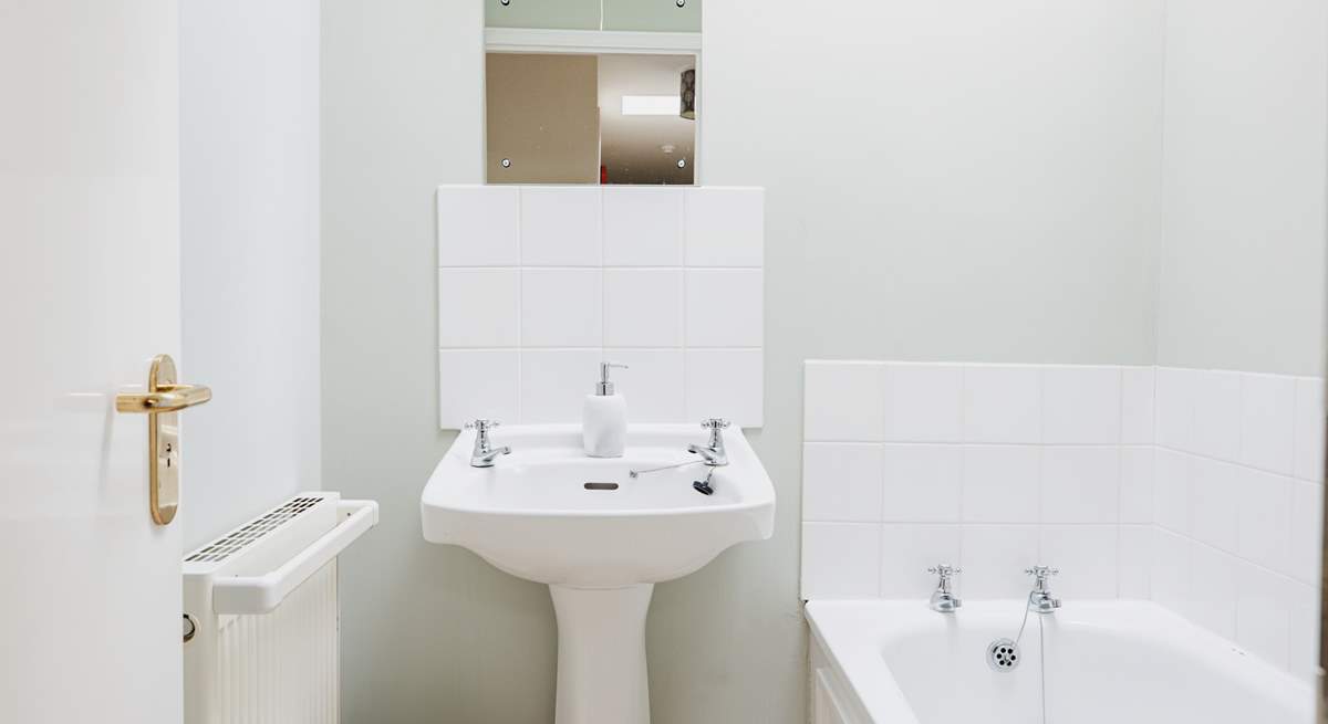 The separate family bathroom is light and cheery, perfect for a soak at the end of the day.