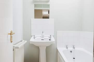 The separate family bathroom is light and cheery, perfect for a soak at the end of the day.