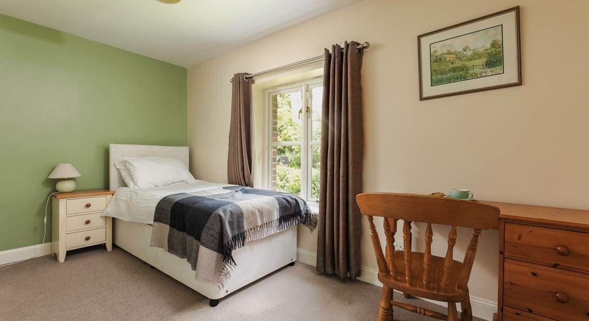 This is Bluebell, a spacious single bedroom that looks out over the front of the cottage. It has an en suite shower-room.