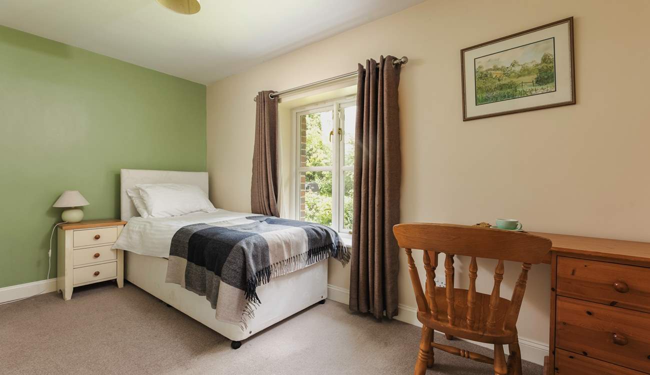 This is Bluebell, a spacious single bedroom that looks out over the front of the cottage. It has an en suite shower-room.