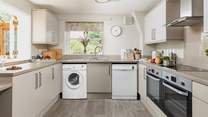 A modern kitchen creates a lovely space to prepare holiday meals. There is also an area of lowered worktop making the room accessible for wheelchair users.