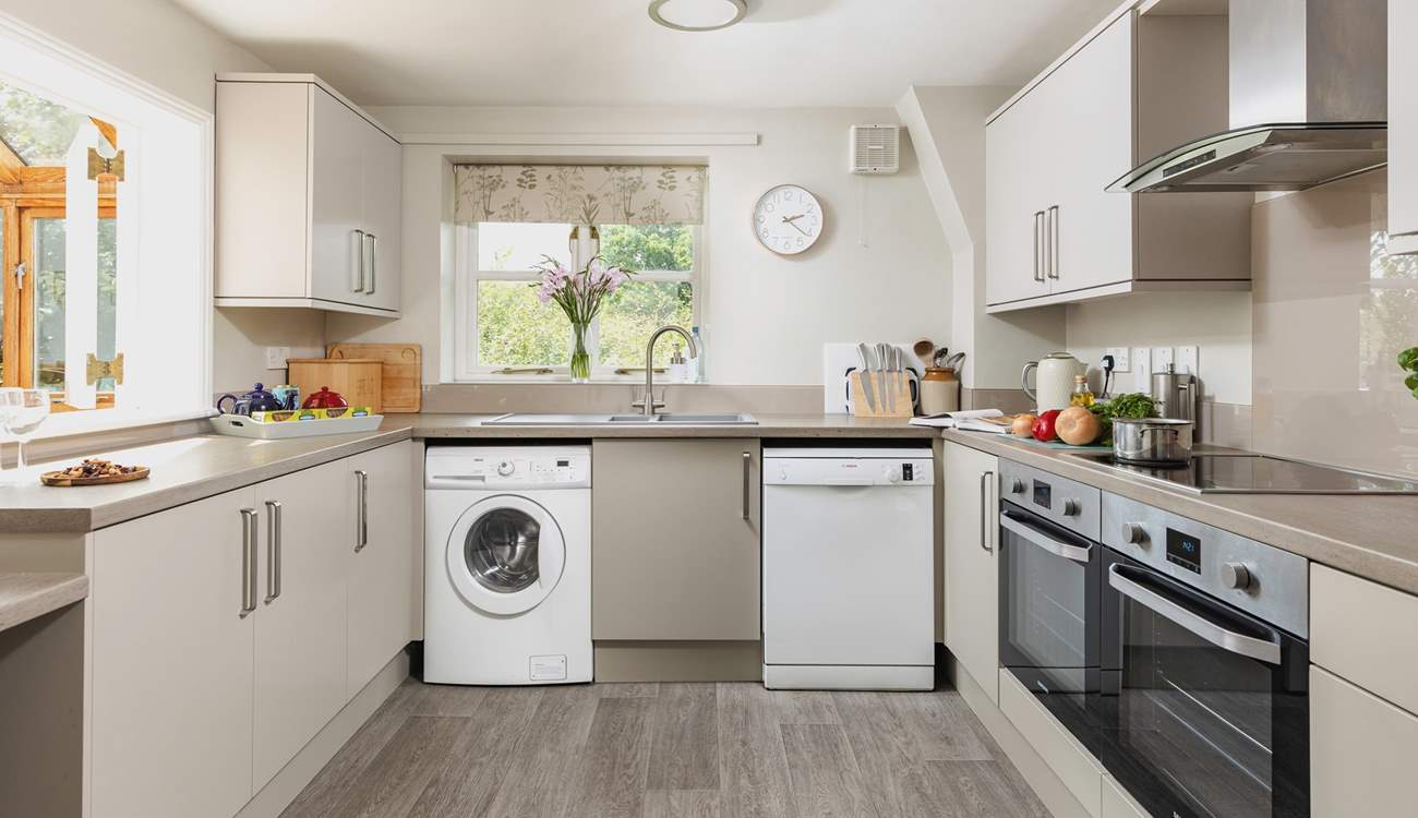 A modern kitchen creates a lovely space to prepare holiday meals. There is also an area of lowered worktop making the room accessible for wheelchair users.