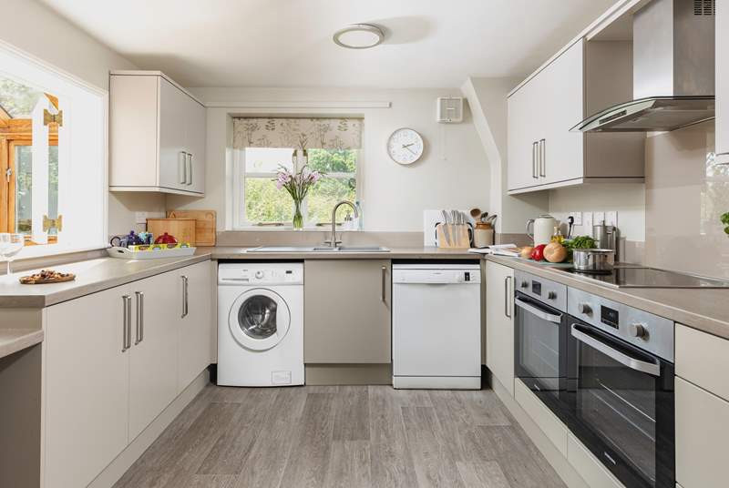 A modern kitchen creates a lovely space to prepare holiday meals. There is also an area of lowered worktop making the room accessible for wheelchair users.