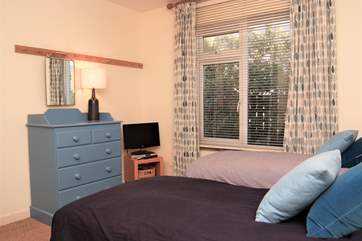 The second twin bedroom has a TV too.