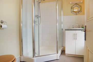 The en suite shower-room has a large corner shower cubicle, and also enjoys the view.