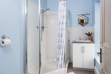 The en suite shower-room has a large corner shower cubicle, and also enjoys the view.