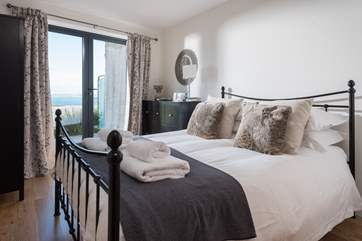 The main bedroom, with patio door leading out onto the balcony.
