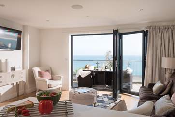 The bi-fold doors open wide, to allow the outside in.
