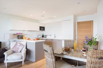 The gorgeous open plan living-area, beautifully furnished in pastel colours.