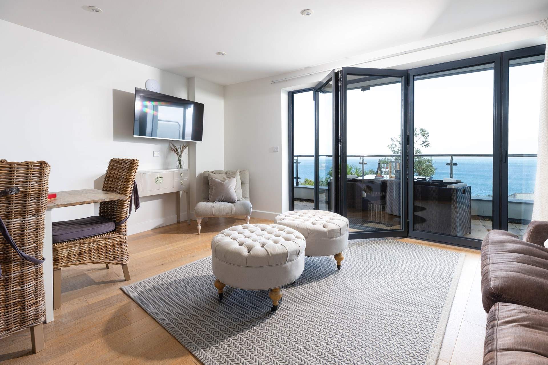 An open plan contemporary living space with panoramic sea views.