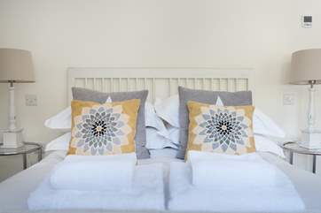 Soft greys and yellow complement the second bedroom perfectly.