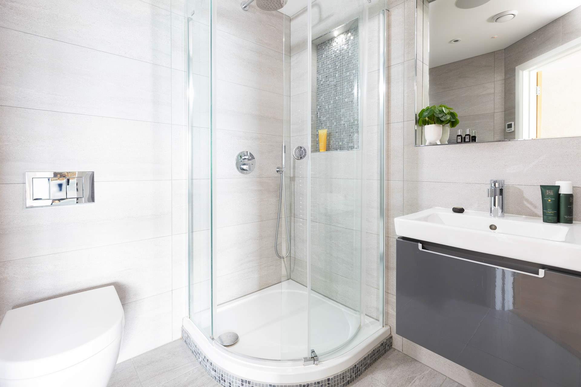 Sophisticated and sleek with floor to ceiling tiling.