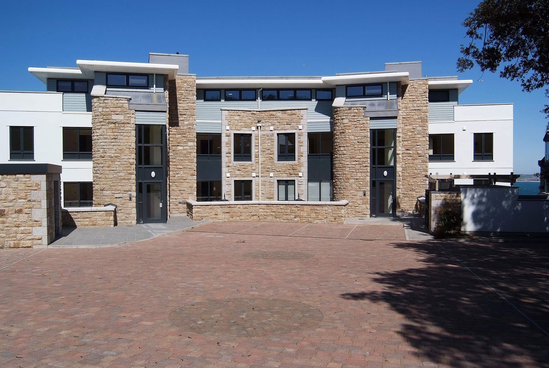 The entrance and private  parking-area to the apartments.