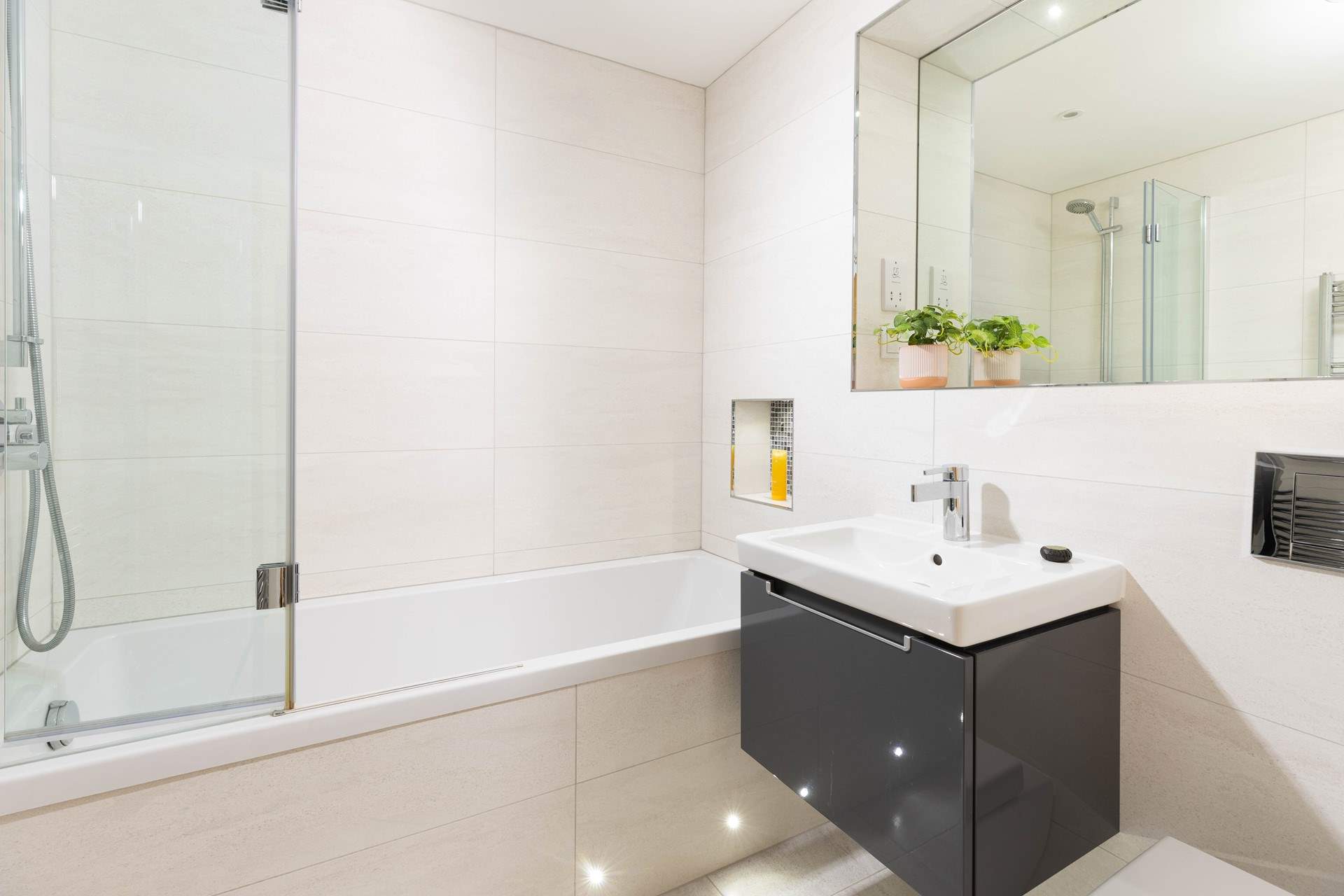 The luxury family bathroom is spacious and inviting, soak away a sandy day.