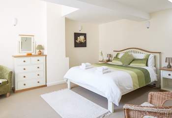 This is bedroom 2 with a king-sized bed and lots of storage space.