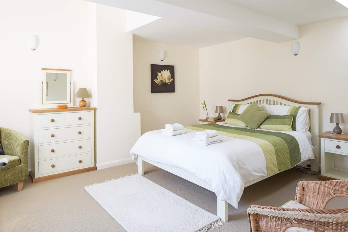 This is bedroom 2 with a king-sized bed and lots of storage space.