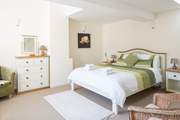 This is bedroom 2 with a king-sized bed and lots of storage space.